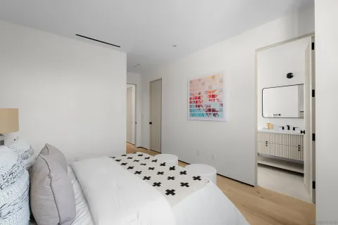 a bathroom with a bathtub shower sink vanity and toilet