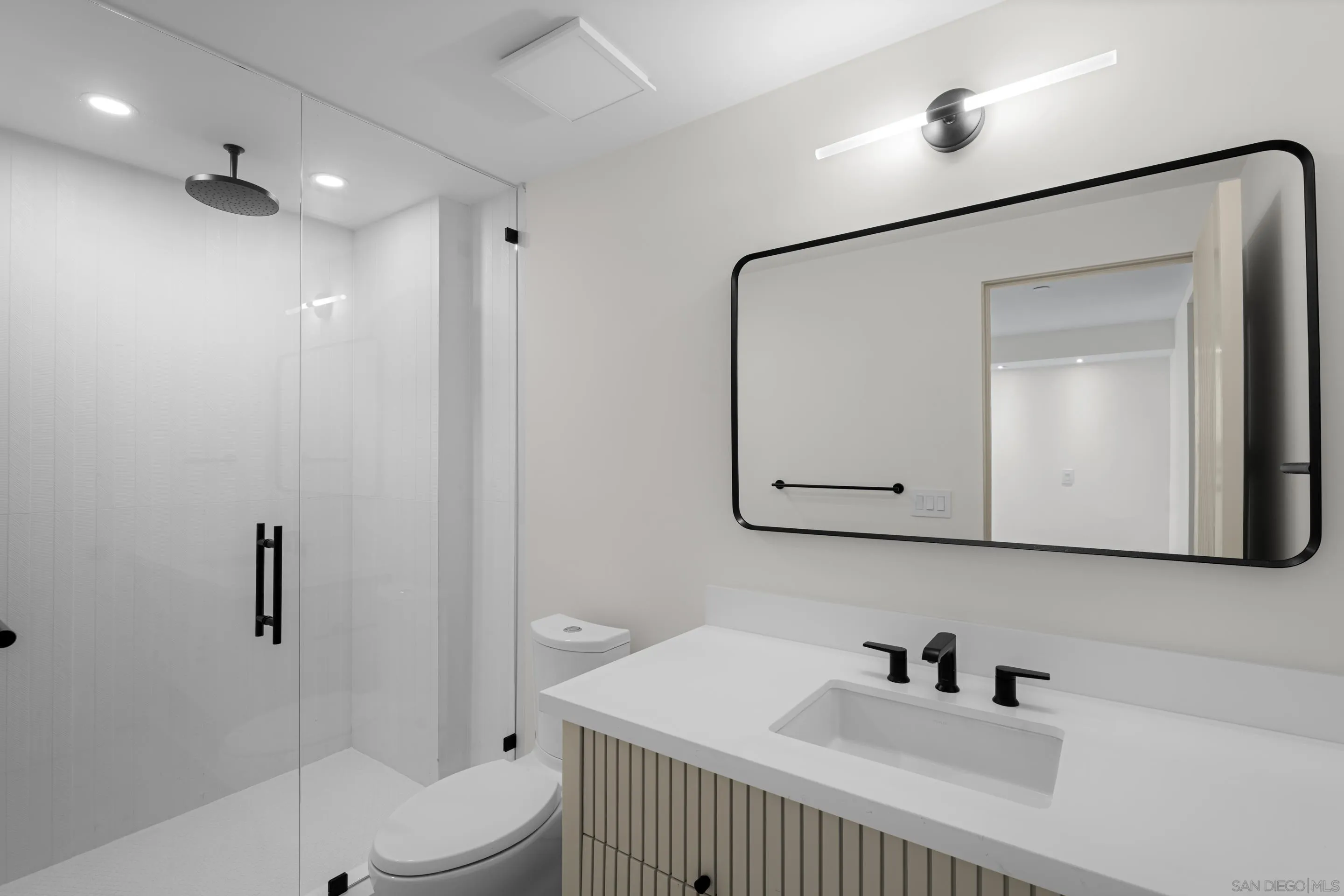 242 Playa Del Norte Street La Jolla, CA 92037 - Photo 27 of 32 a bathroom with a sink a toilet and shower