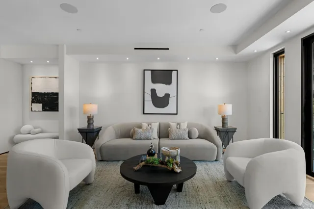 a living room with furniture and white walls