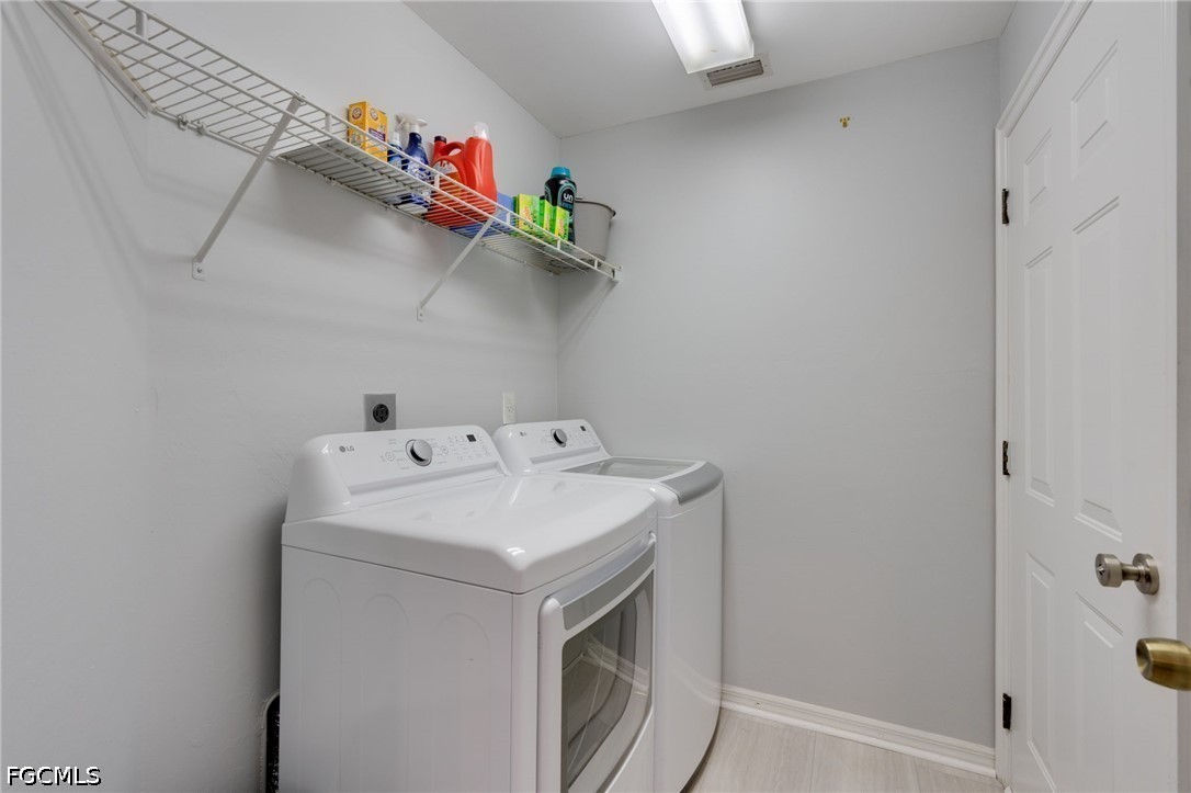 3801 28th Street Southwest Lehigh Acres, FL 33976 - Photo 13 of 37 a utility room with dryer and washer