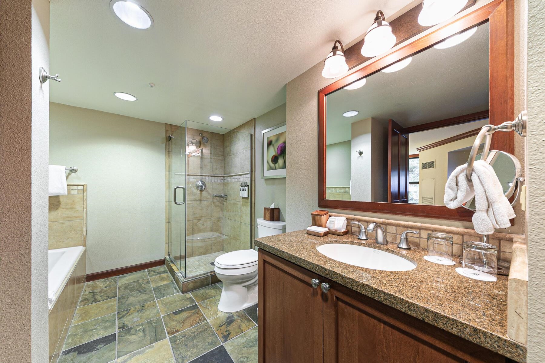 400 Resort Road, Unit 418420 Olympic Valley, CA 96146 - Photo 16 of 26 a bathroom with a granite countertop sink a toilet a mirror and shower