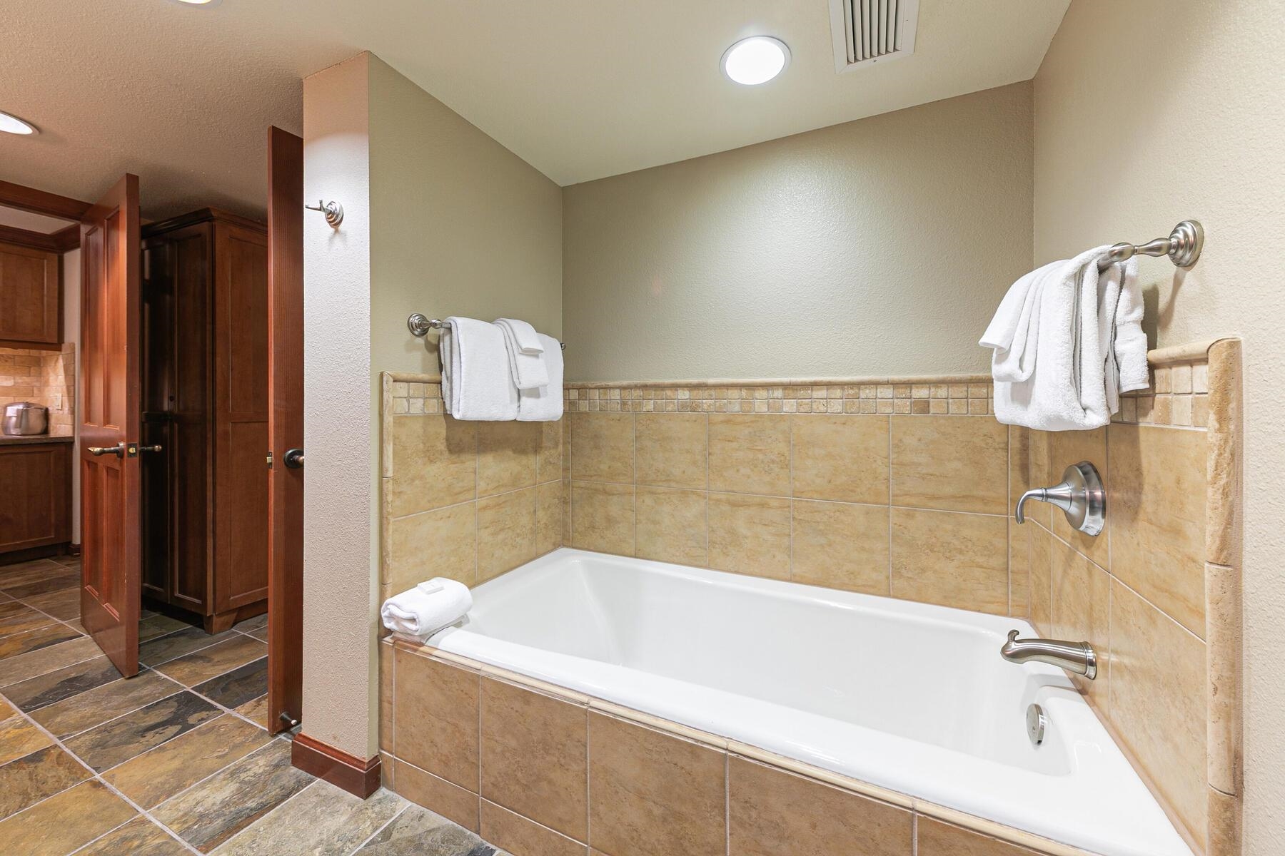 400 Resort Road, Unit 418420 Olympic Valley, CA 96146 - Photo 17 of 26 a bathroom with a bathtub and a shower