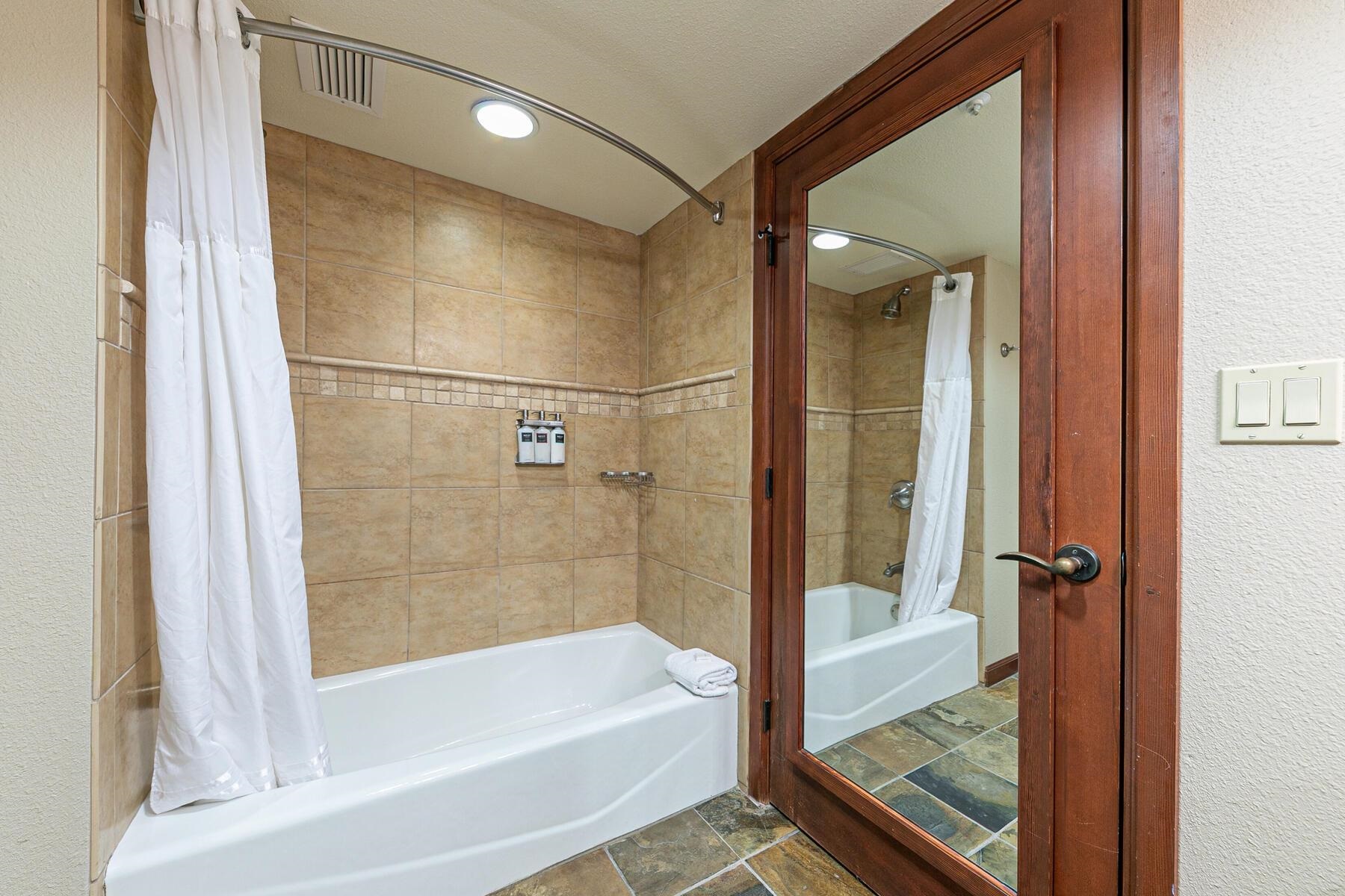 400 Resort Road, Unit 418420 Olympic Valley, CA 96146 - Photo 22 of 26 a bathroom with a bathtub and a shower