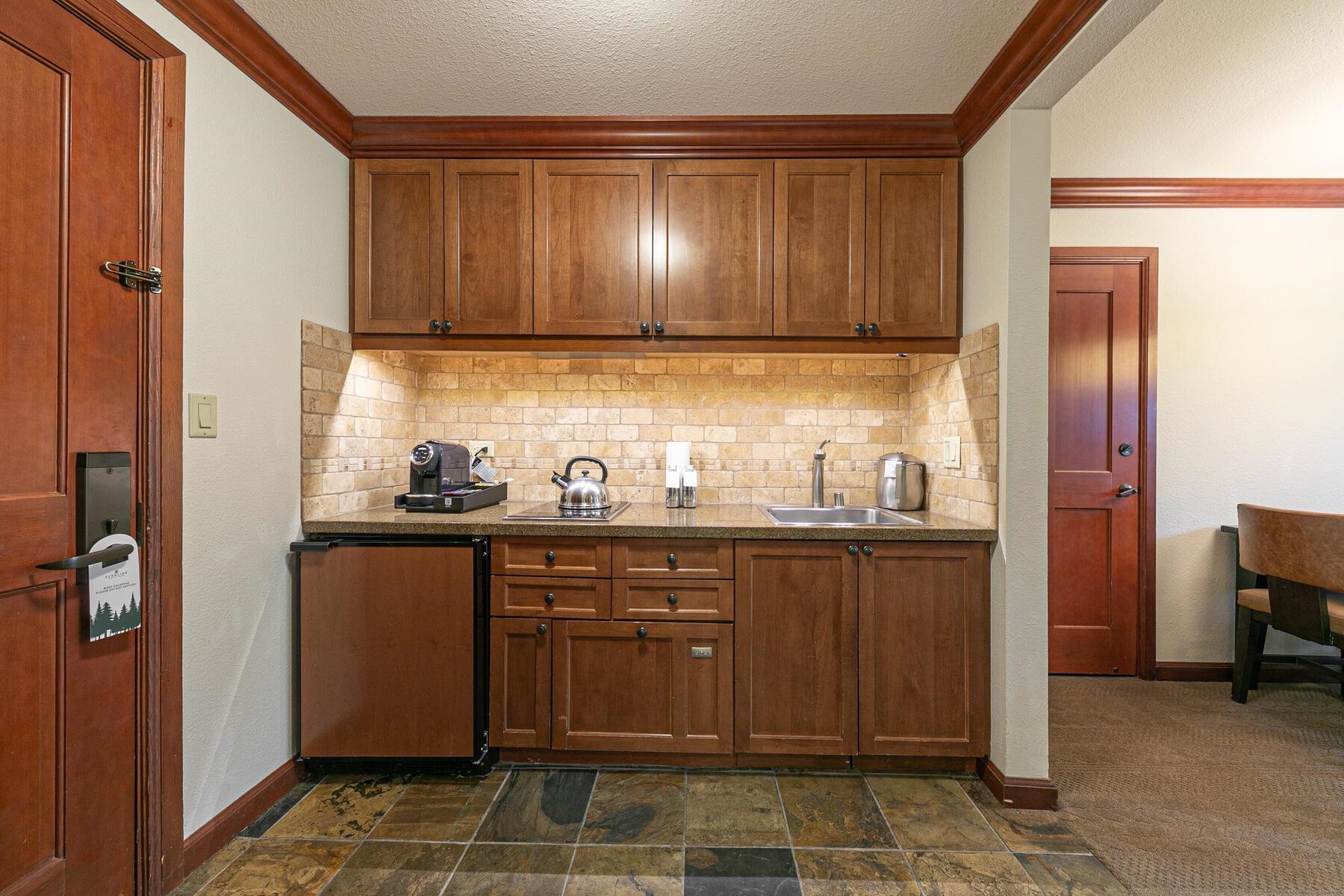 400 Resort Road, Unit 418420 Olympic Valley, CA 96146 - Photo 7 of 26 a kitchen with stainless steel appliances granite countertop wooden cabinets a sink and dishwasher