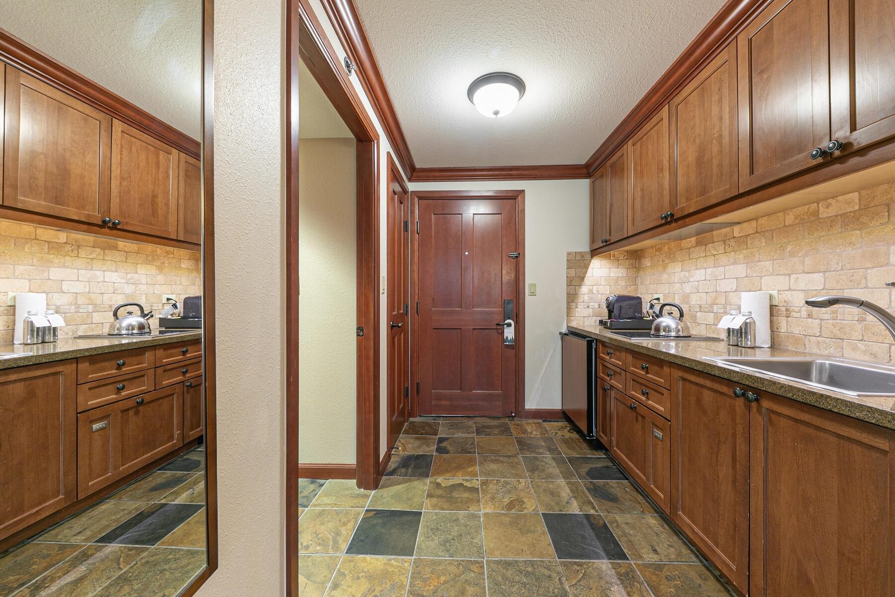 400 Resort Road, Unit 418420 Olympic Valley, CA 96146 - Photo 8 of 26 a kitchen with granite countertop stainless steel appliances and wooden cabinets