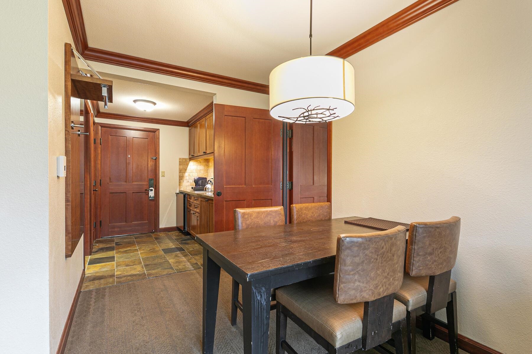 400 Resort Road, Unit 418420 Olympic Valley, CA 96146 - Photo 10 of 26 a kitchen with a table and chairs