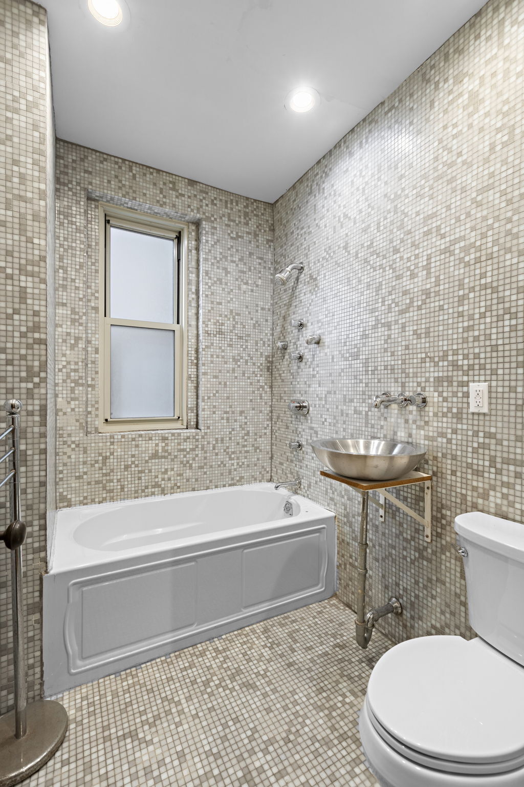 435 Convent Avenue, Unit 32 Manhattan, NY 10031 - Photo 10 of 12 a bathroom with a toilet a sink and bathtub