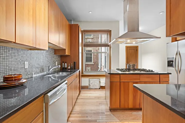 a kitchen with stainless steel appliances granite countertop a sink stove and refrigerator