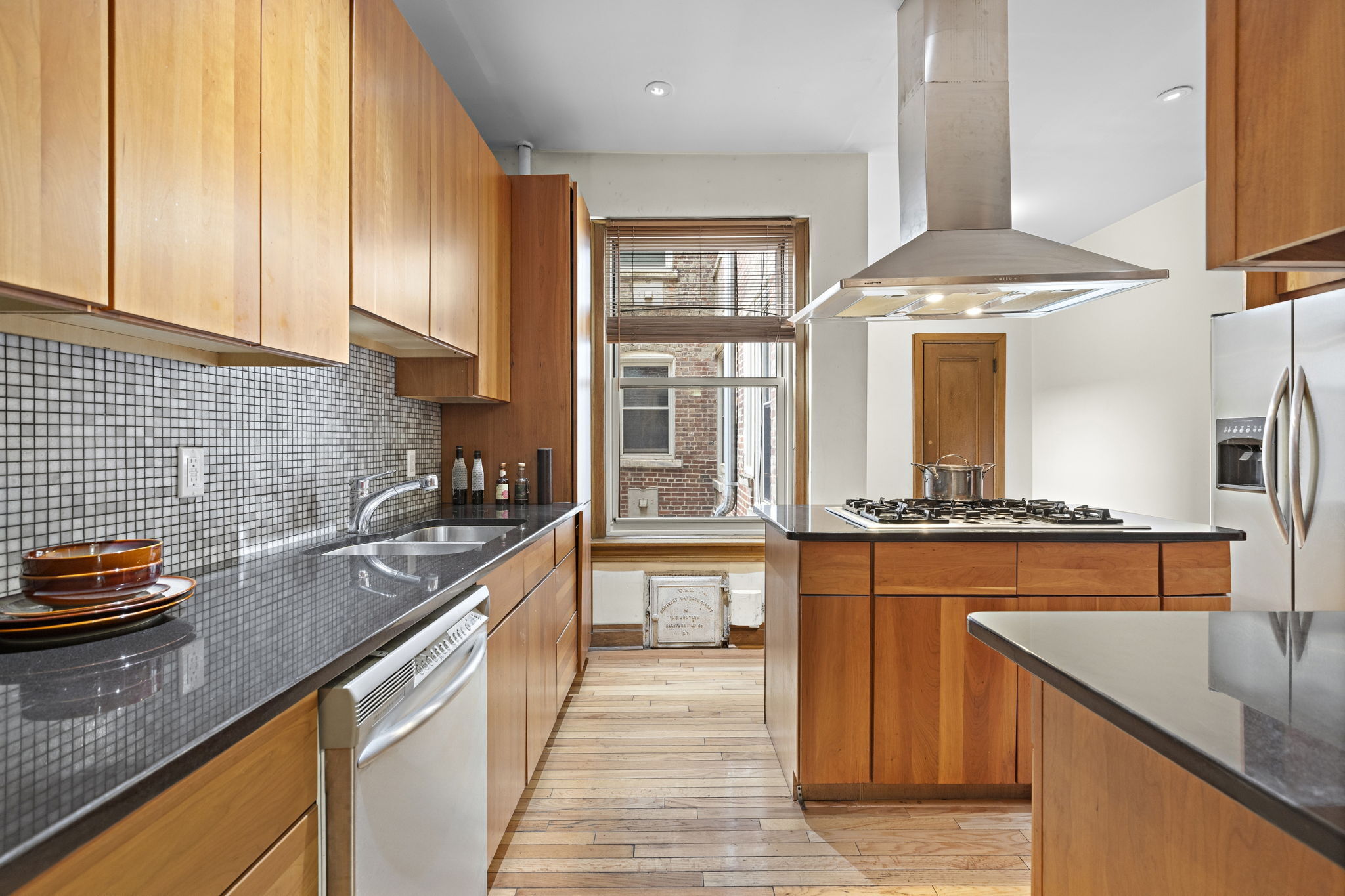 435 Convent Avenue, Unit 32 Manhattan, NY 10031 - Photo 5 of 12 a kitchen with stainless steel appliances granite countertop a sink stove and refrigerator