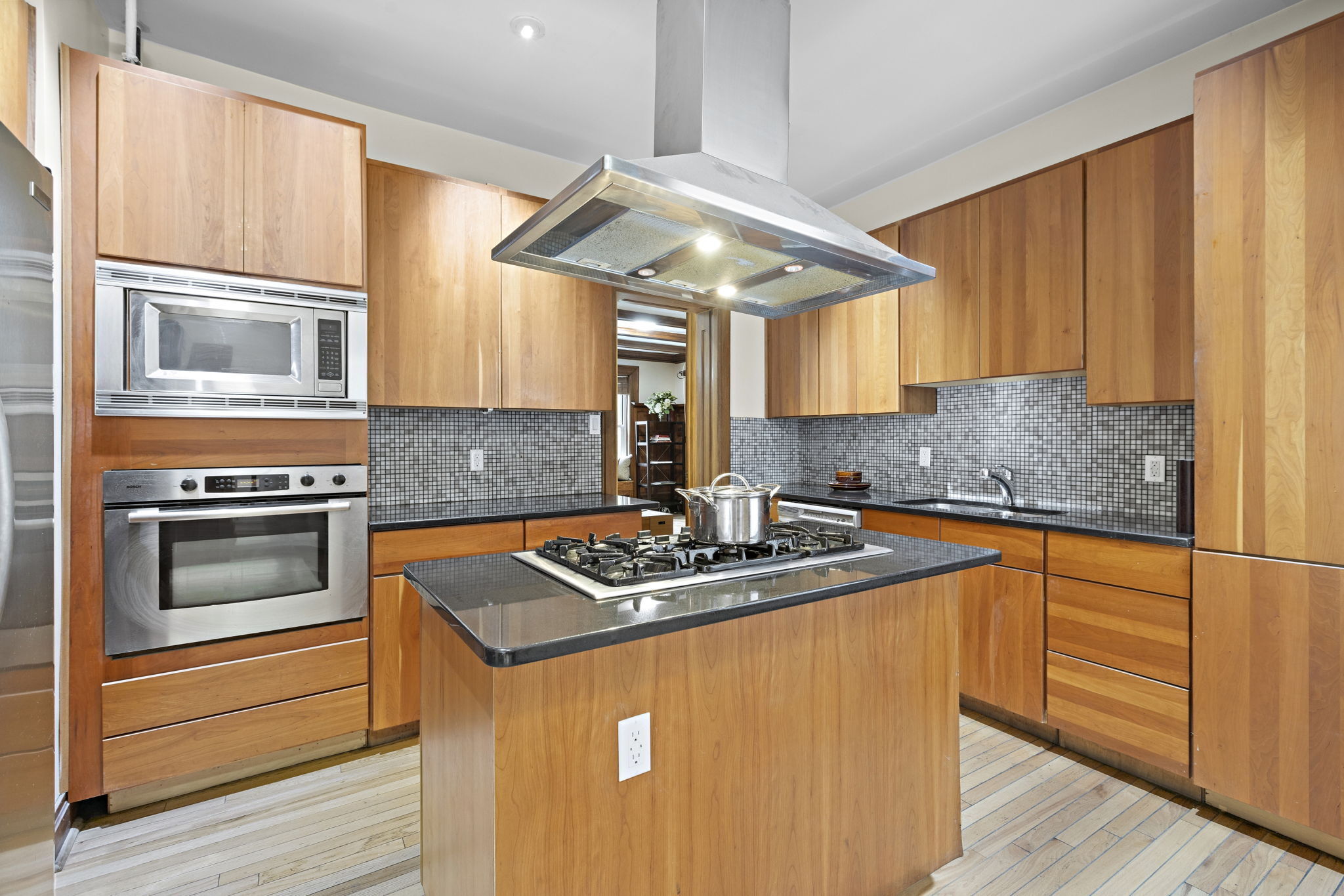 435 Convent Avenue, Unit 32 Manhattan, NY 10031 - Photo 6 of 12 a kitchen with stainless steel appliances granite countertop a sink stove and cabinets
