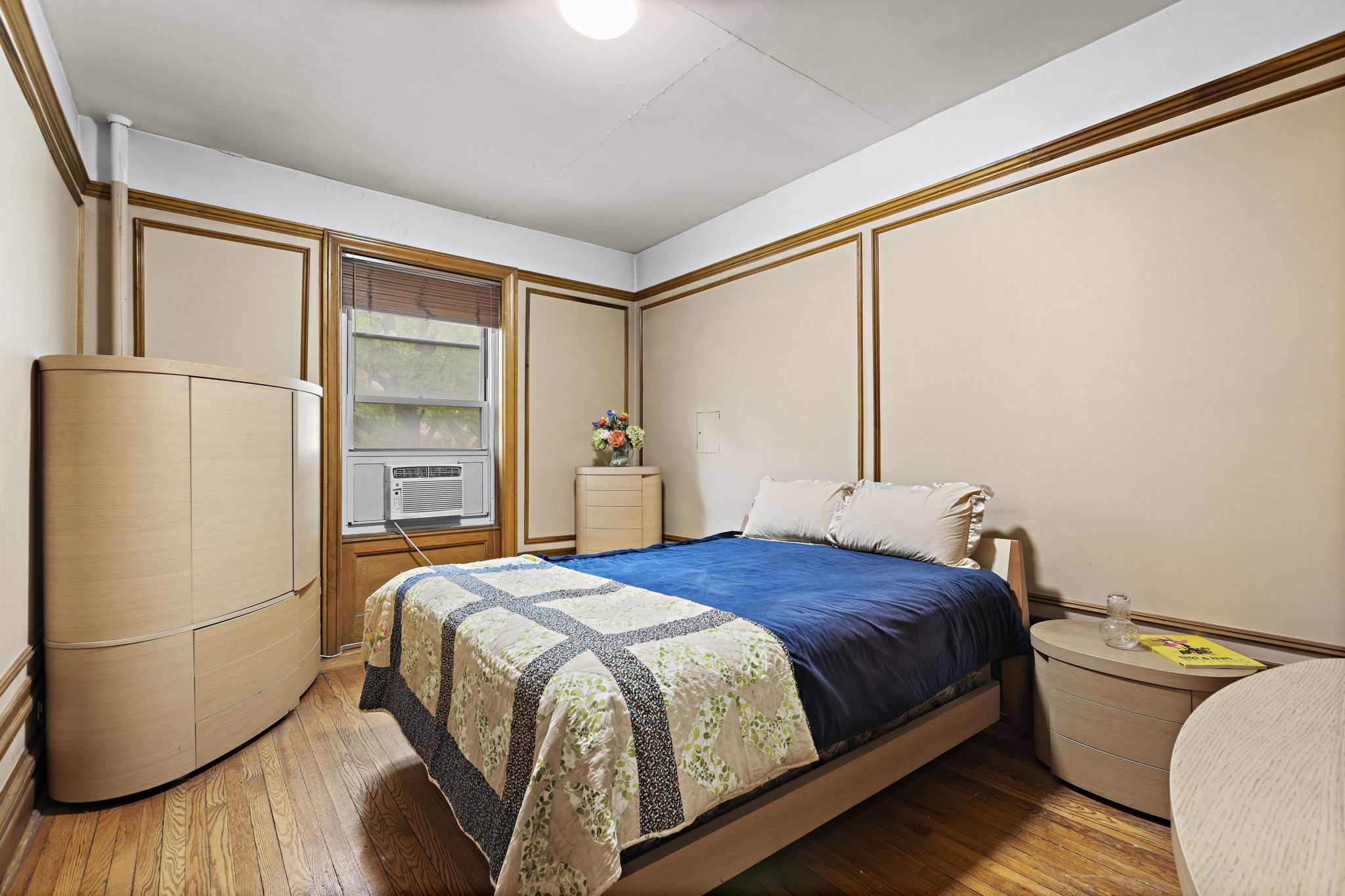 435 Convent Avenue, Unit 32 Manhattan, NY 10031 - Photo 8 of 12 a bedroom with a bed and a refrigerator