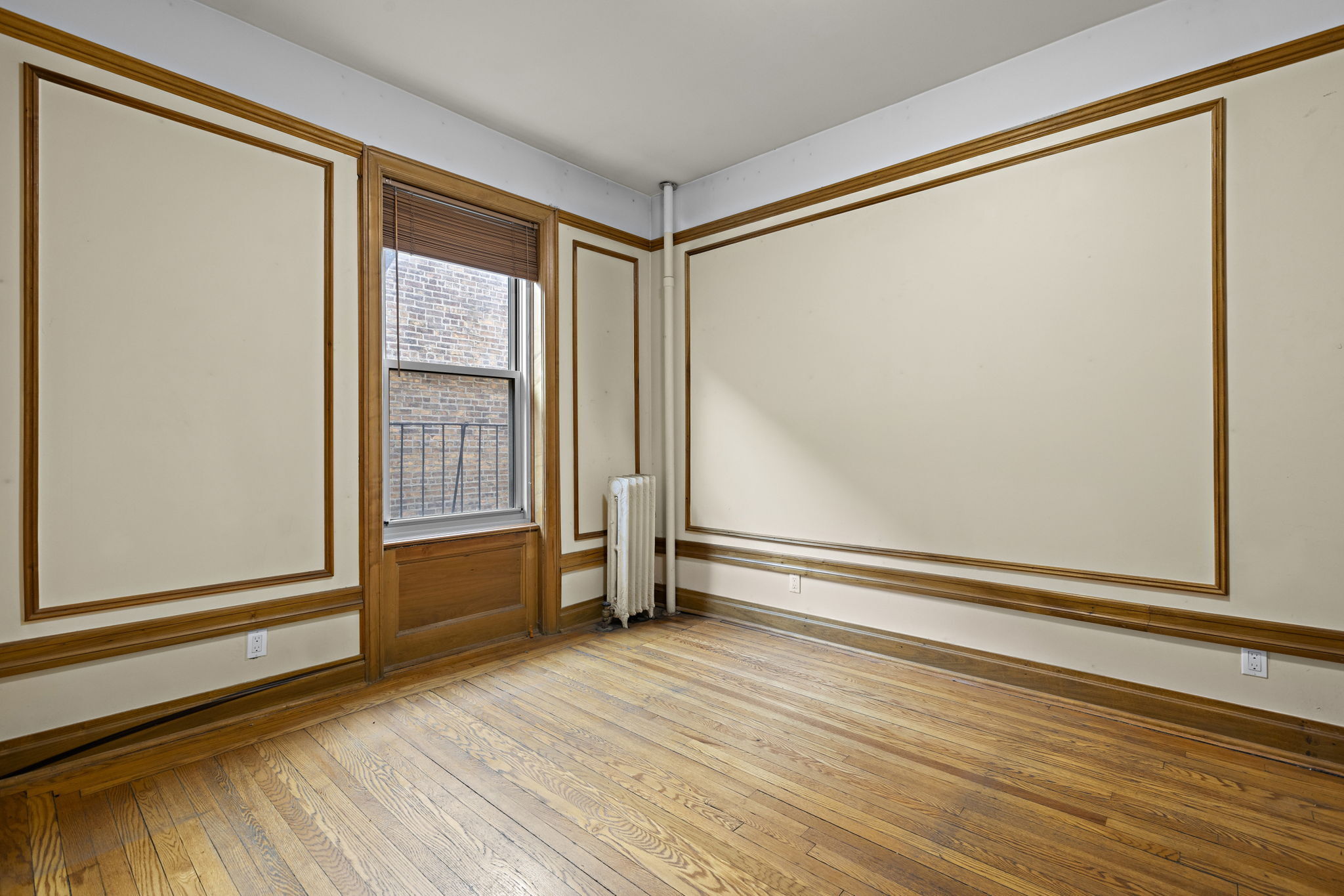 435 Convent Avenue, Unit 32 Manhattan, NY 10031 - Photo 9 of 12 a view of empty room with wooden floor and fan