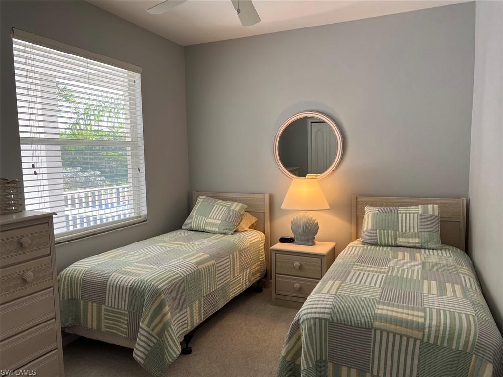 7625 Arbor Lake Court, Unit 332 Naples, FL 34112 - Photo 15 of 26 a bedroom with two beds lamp and a window