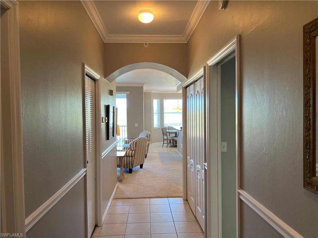 7625 Arbor Lake Court, Unit 332 Naples, FL 34112 - Photo 4 of 26 a hallway with a view of living room