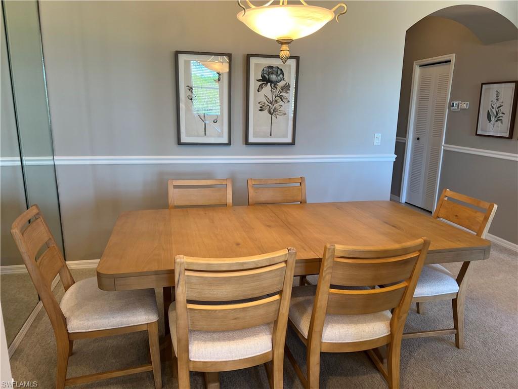 7625 Arbor Lake Court, Unit 332 Naples, FL 34112 - Photo 8 of 26 a blue table sitting next to a white chair