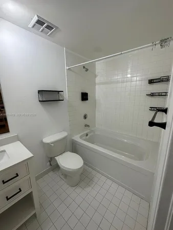 a bathroom with a shower a toilet and a bathtub