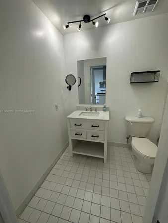 a bathroom with a sink a toilet and mirror