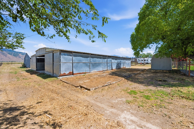 3732 Campbell Road Tooele, UT 84074 - Photo 53 of 69 Metal-sided barn structure featuring multiple stalls and an open-front shed