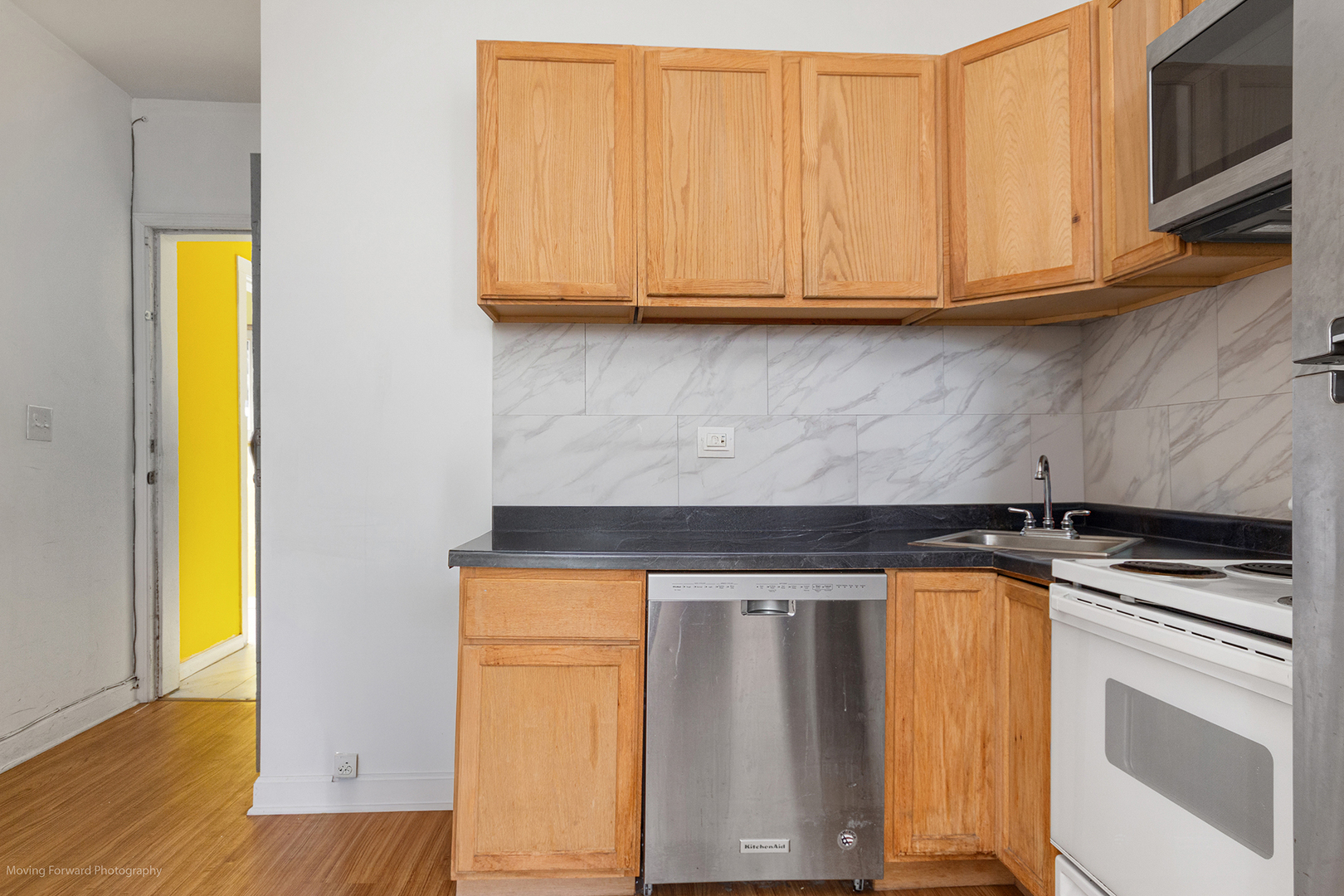 1900 South Throop Street Chicago, IL 60608 - Photo 15 of 42 a kitchen with stainless steel appliances granite countertop a stove a sink and a microwave