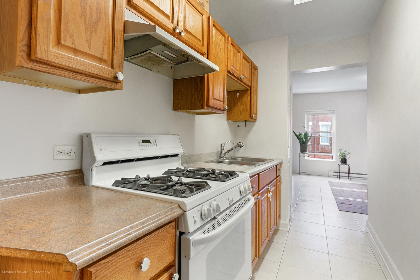 1900 South Throop Street Chicago, IL 60608 - Photo 19 of 42 a kitchen with stainless steel appliances granite countertop a stove a sink and a microwave