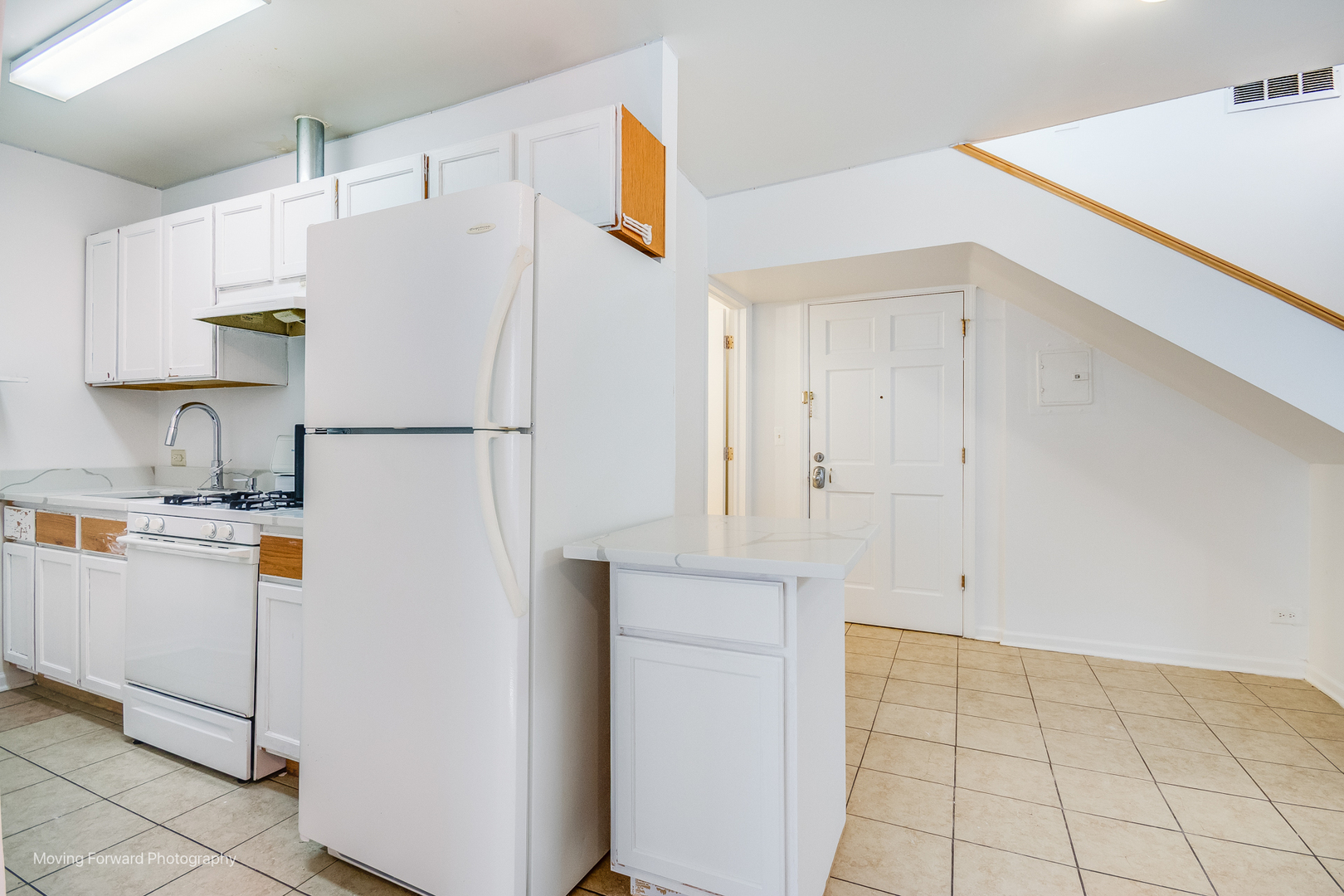 1900 South Throop Street Chicago, IL 60608 - Photo 29 of 42 a white refrigerator freezer sitting in a kitchen