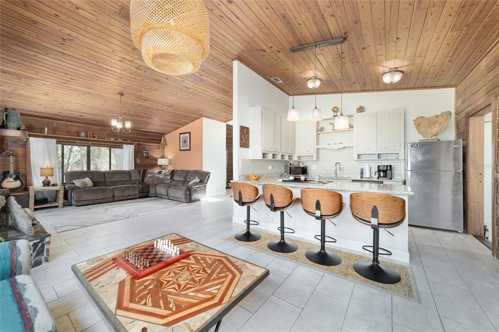 3510 Southwest 5th Court Ocala, FL 34471 - Photo 12 of 44 a living room with stainless steel appliances kitchen island granite countertop furniture and a rug