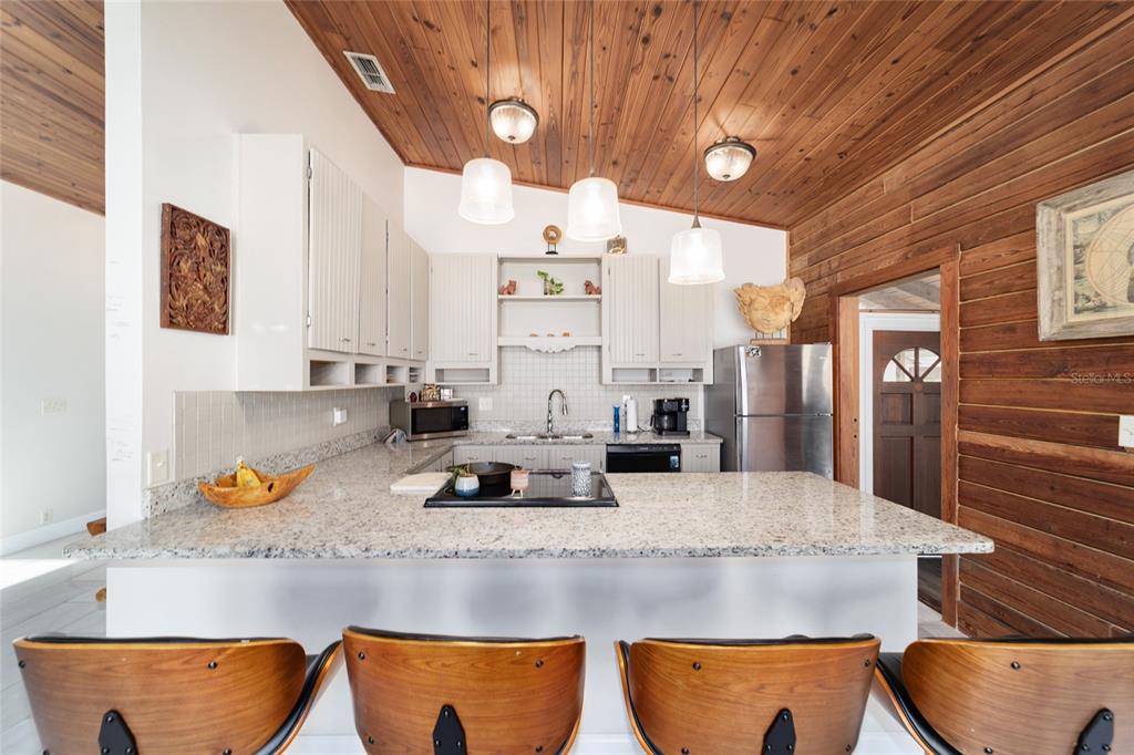 3510 Southwest 5th Court Ocala, FL 34471 - Photo 14 of 44 a kitchen with stainless steel appliances granite countertop a sink a stove and a wooden cabinets