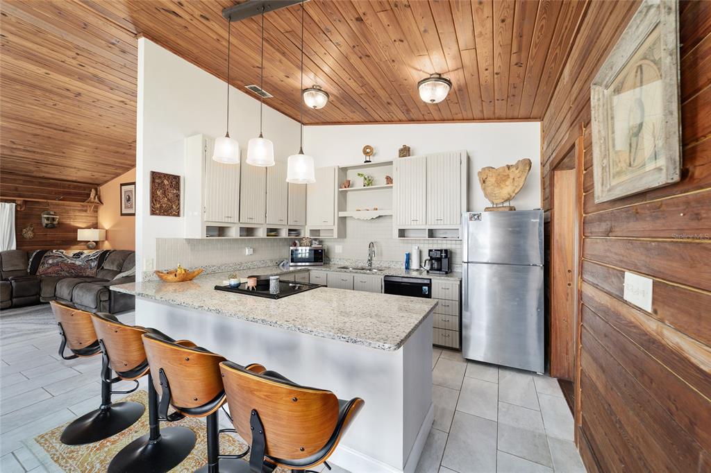 3510 Southwest 5th Court Ocala, FL 34471 - Photo 15 of 44 a kitchen with stainless steel appliances a sink a stove a refrigerator and cabinets