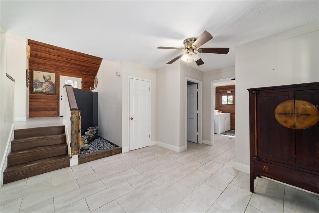 3510 Southwest 5th Court Ocala, FL 34471 - Photo 21 of 44 a view of a hallway to a room with wooden floor and a ceiling fan