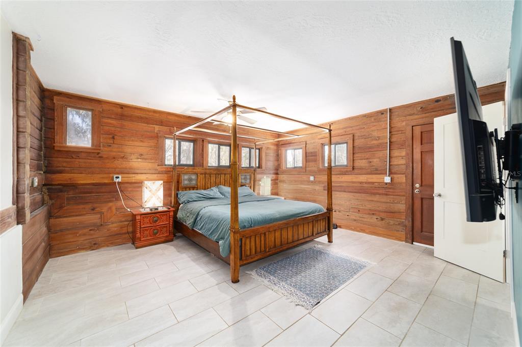 3510 Southwest 5th Court Ocala, FL 34471 - Photo 22 of 44 a bedroom with a bed a flat screen tv and a walk in closet