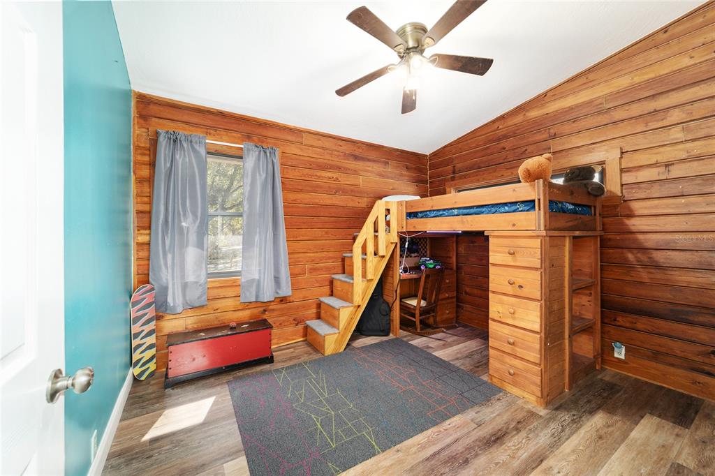 3510 Southwest 5th Court Ocala, FL 34471 - Photo 32 of 44 a bedroom with furniture and a chandelier