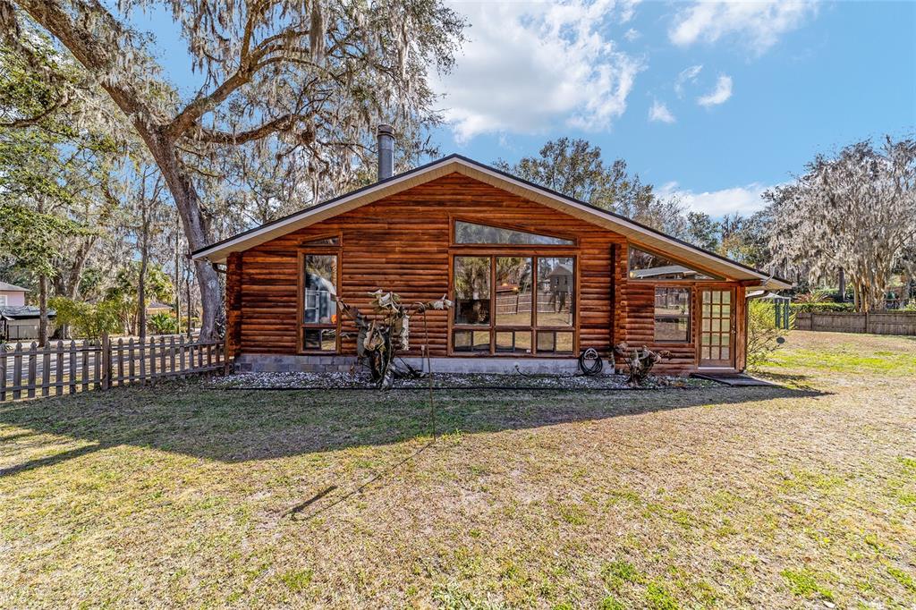 3510 Southwest 5th Court Ocala, FL 34471 - Photo 39 of 44 a view of a house with a small yard and wooden fence