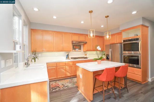 a large kitchen with a table and chairs