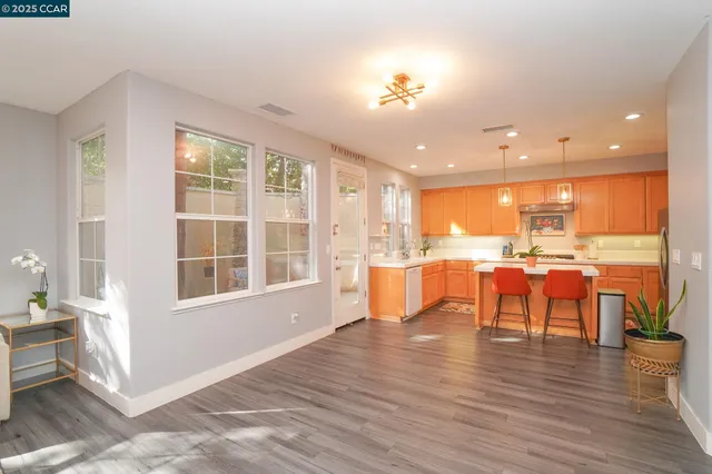 a view of kitchen with dining room and wooden floor