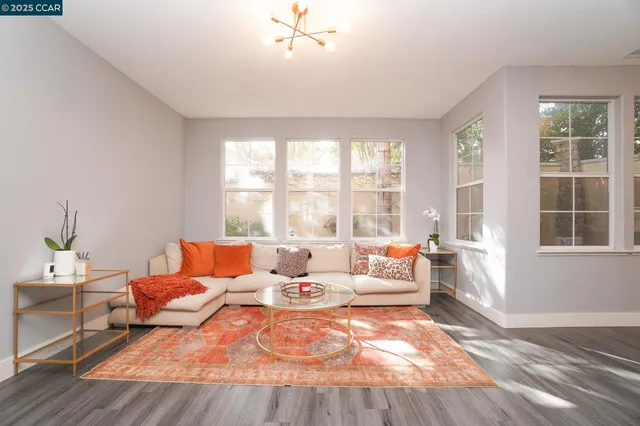 a living room with furniture and large windows