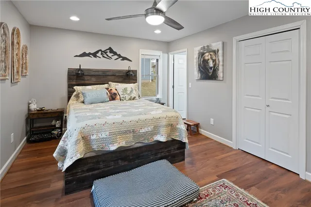 a bedroom with a bed and a mirror