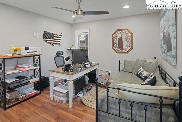 a living room with furniture a rug and a wall painting