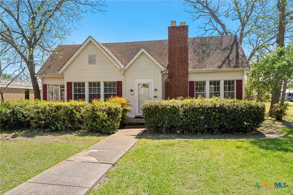 front view of a house next to a yard