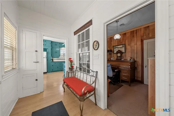 a living room with furniture a window and a potted plant