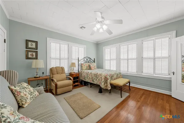 a bedroom with furniture and windows