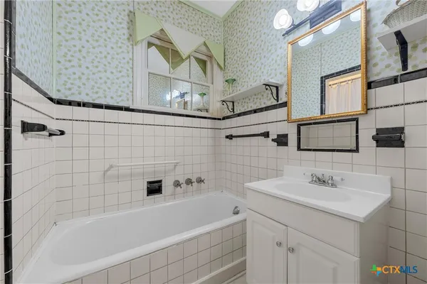 a bathroom with a bathtub and a sink