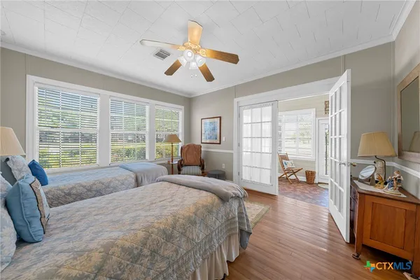 a spacious bedroom with a large bed and a chandelier
