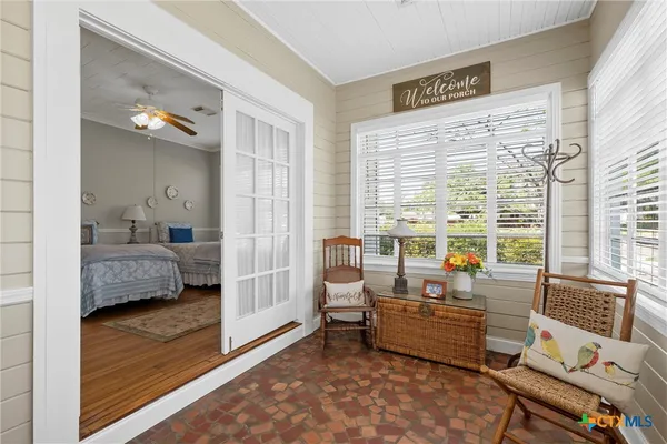 a bedroom with furniture and a large window
