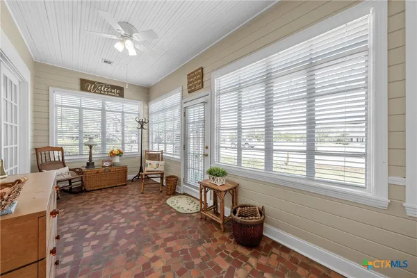 a living room with furniture and floor to ceiling windows