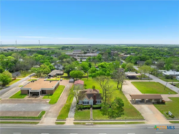 an aerial view of residential houses with outdoor space and swimming pool