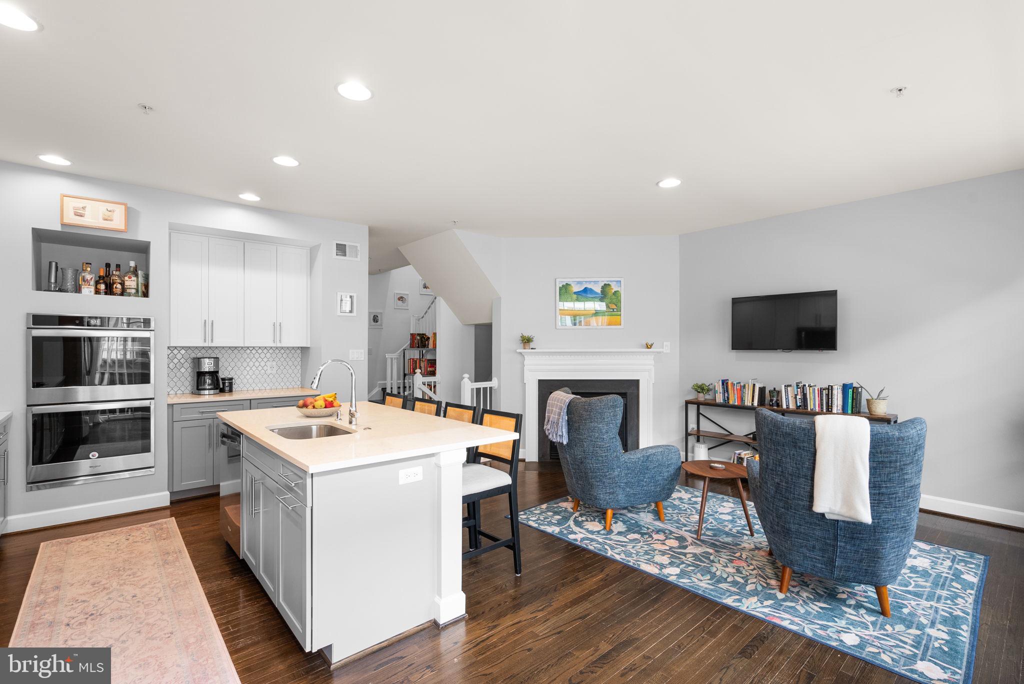 1222 Gaither Road Rockville, MD 20850 - Photo 11 of 42 a open kitchen with stainless steel appliances granite countertop a stove top oven a sink dishwasher and a dining table with wooden floor