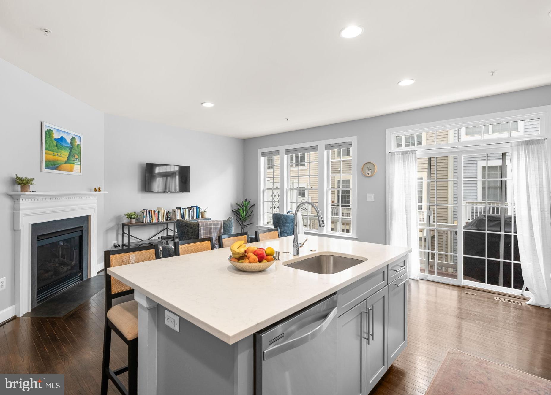 1222 Gaither Road Rockville, MD 20850 - Photo 12 of 42 a kitchen with a sink a stove and wooden floor