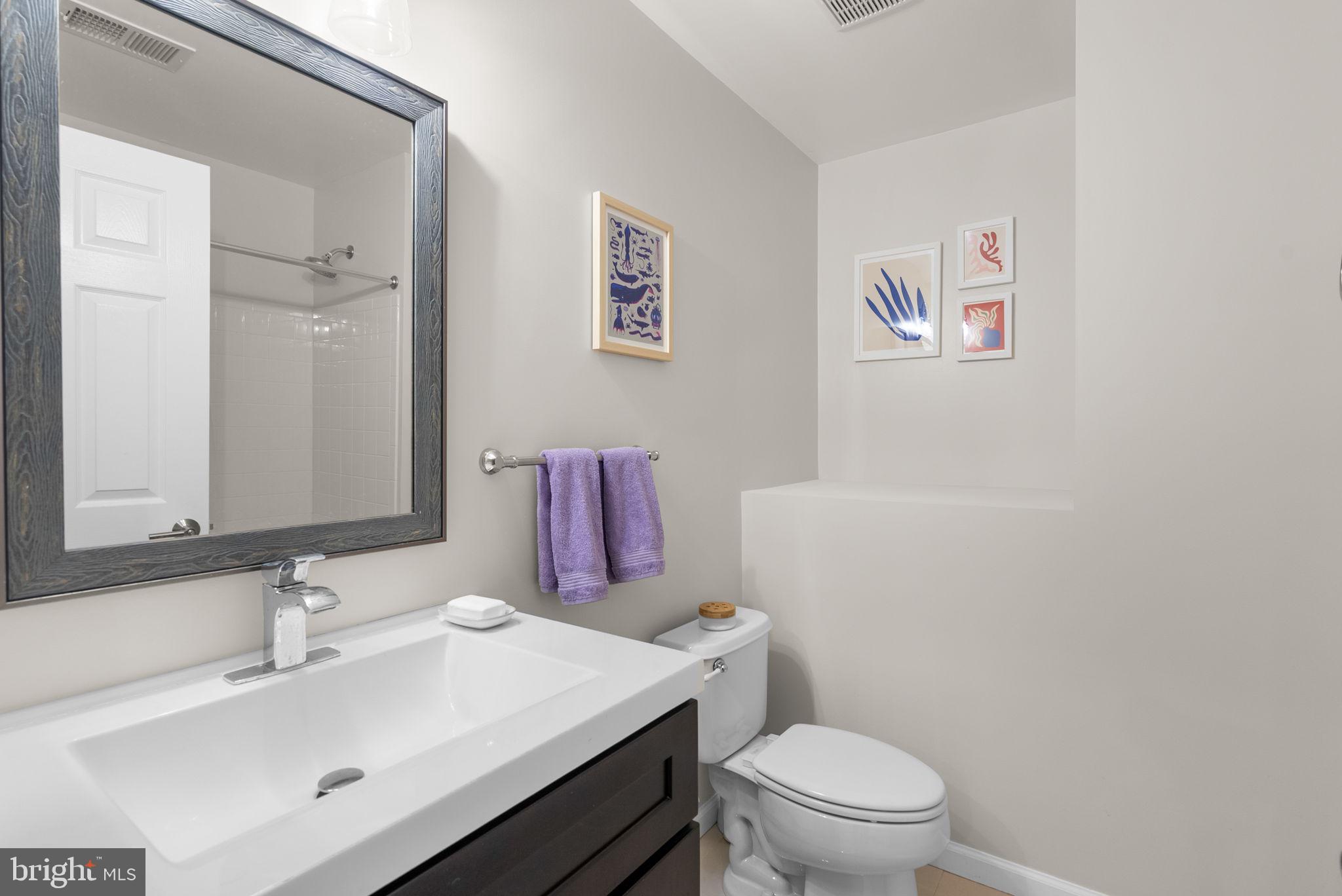 1222 Gaither Road Rockville, MD 20850 - Photo 21 of 42 a bathroom with a sink mirror vanity and toilet