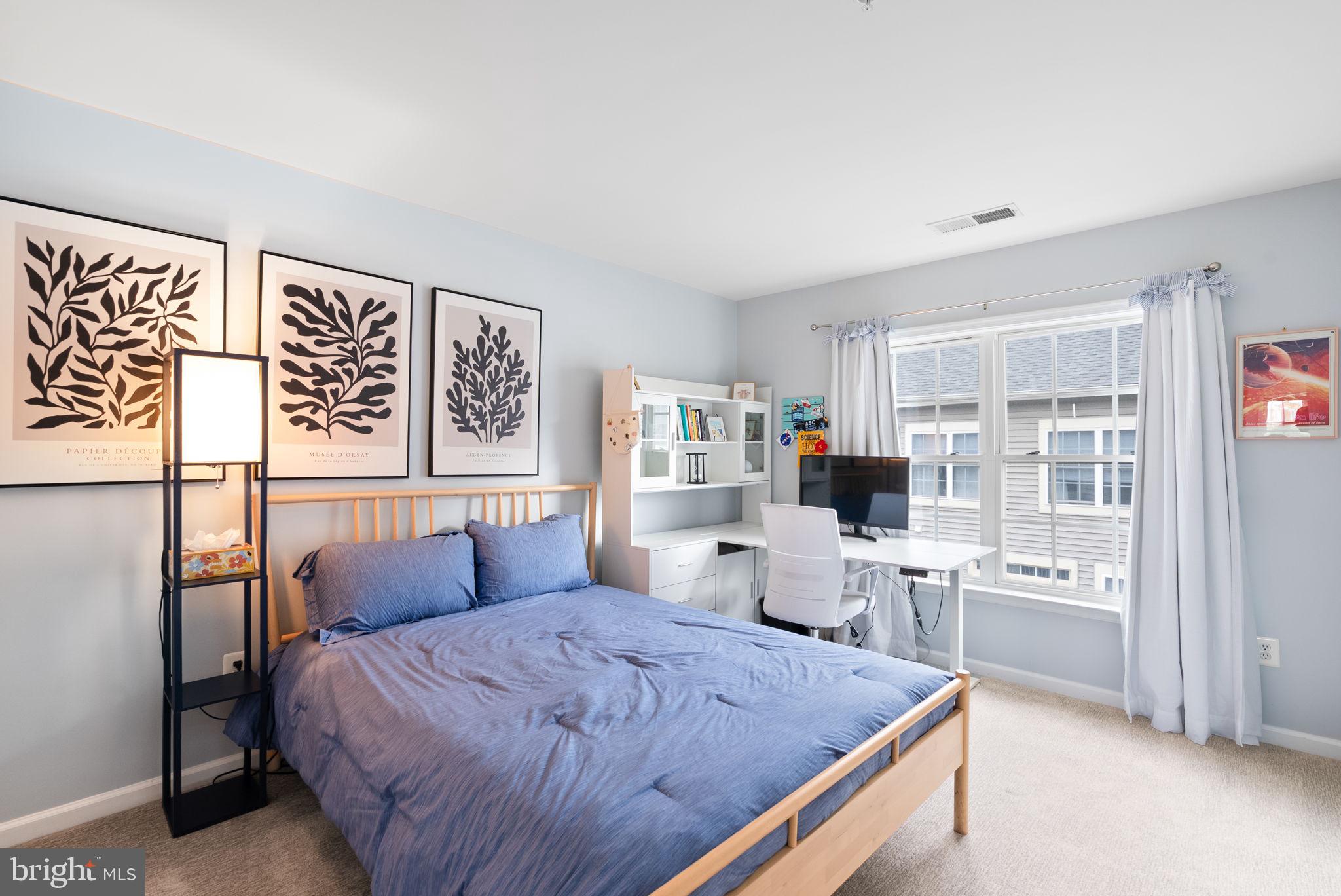 1222 Gaither Road Rockville, MD 20850 - Photo 23 of 42 a bed room with a bed and a television