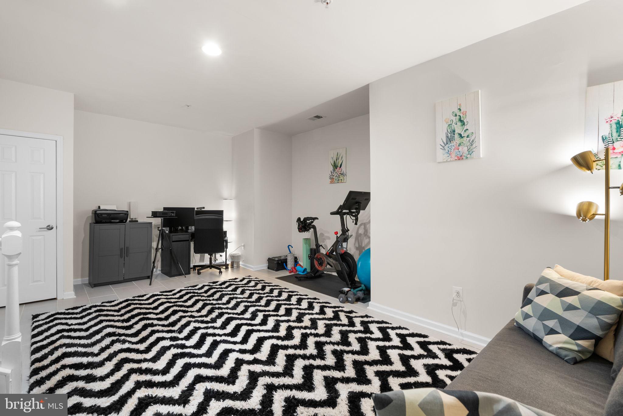 1222 Gaither Road Rockville, MD 20850 - Photo 24 of 42 a bedroom with a bed and wooden floor